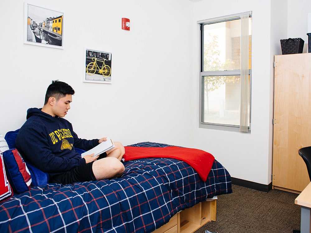 UCR student in his res hall room