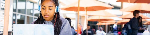 UCR student on her laptop outside the HUB