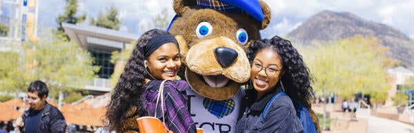 UCR Scotty Mascot hugging students