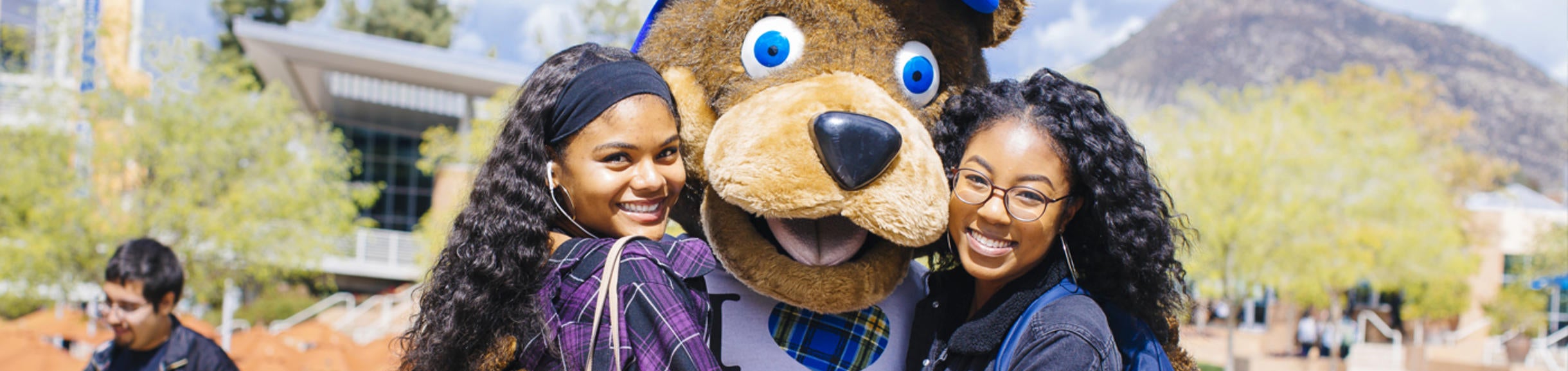 UCR Scotty Mascot hugging students